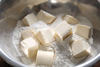 Photo of Making shortcrust pastry. Flour and butter in bowl, closeup