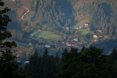 Photo of Beautiful view of forest and village in valley on sunny day