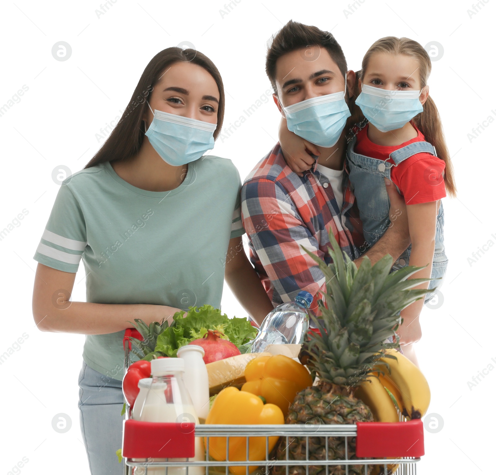 Photo of Family in medical masks with shopping cart full of groceries on white background