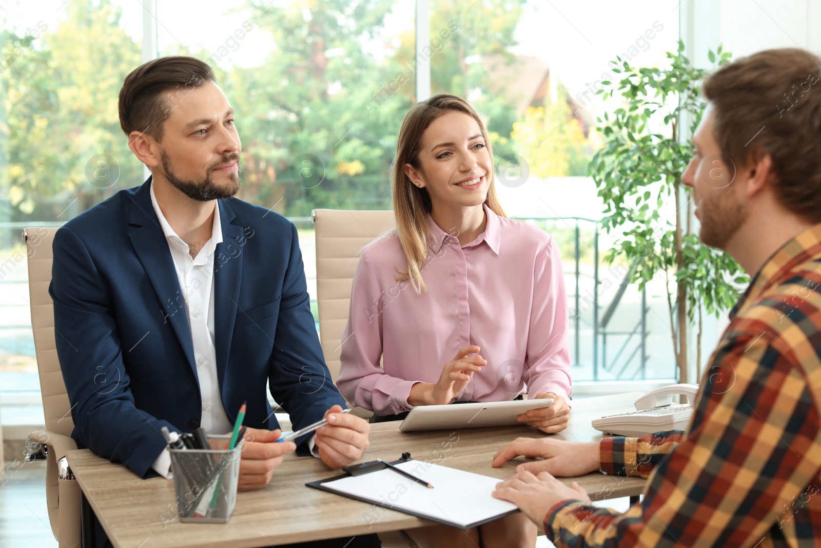 Photo of Human resources commission conducting job interview with applicant in office