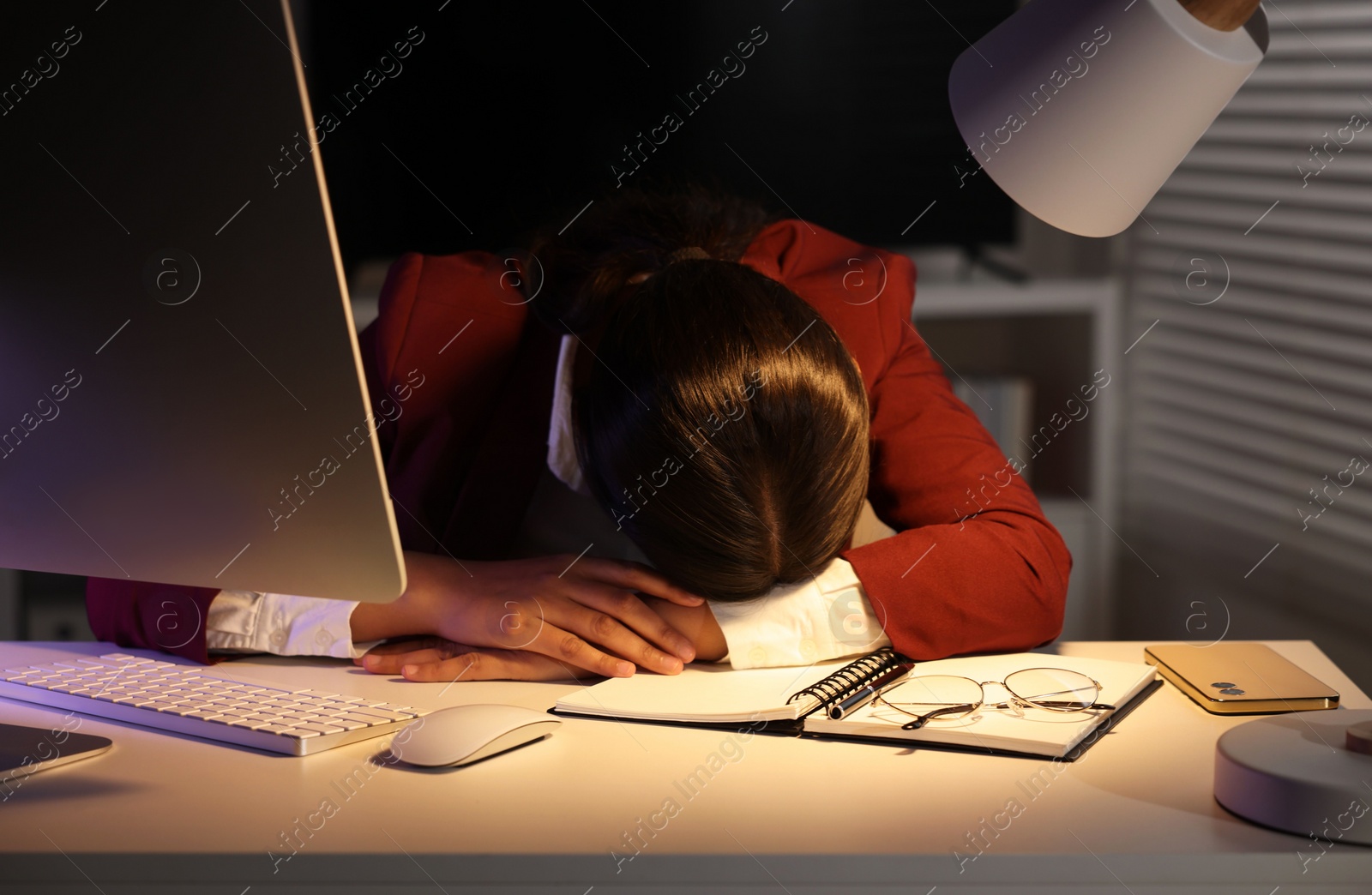 Photo of Tired overworked businesswoman at table in office