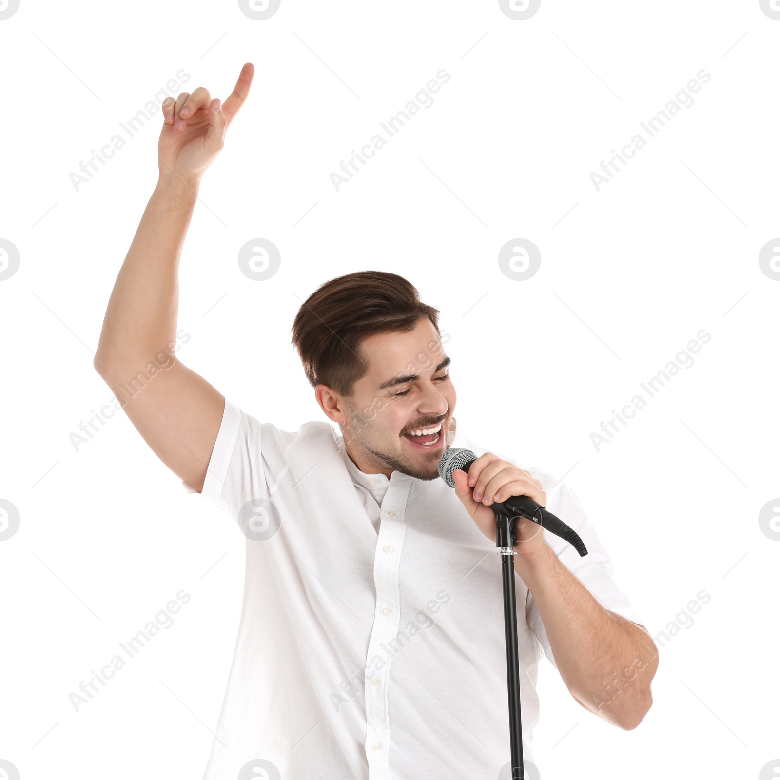 Photo of Young handsome man singing in microphone on white background