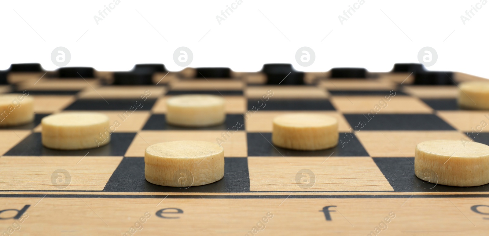 Photo of Wooden checkerboard with game pieces isolated on white, closeup