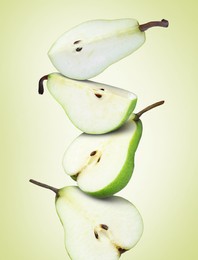 Image of Cut fresh ripe pears on green yellow background