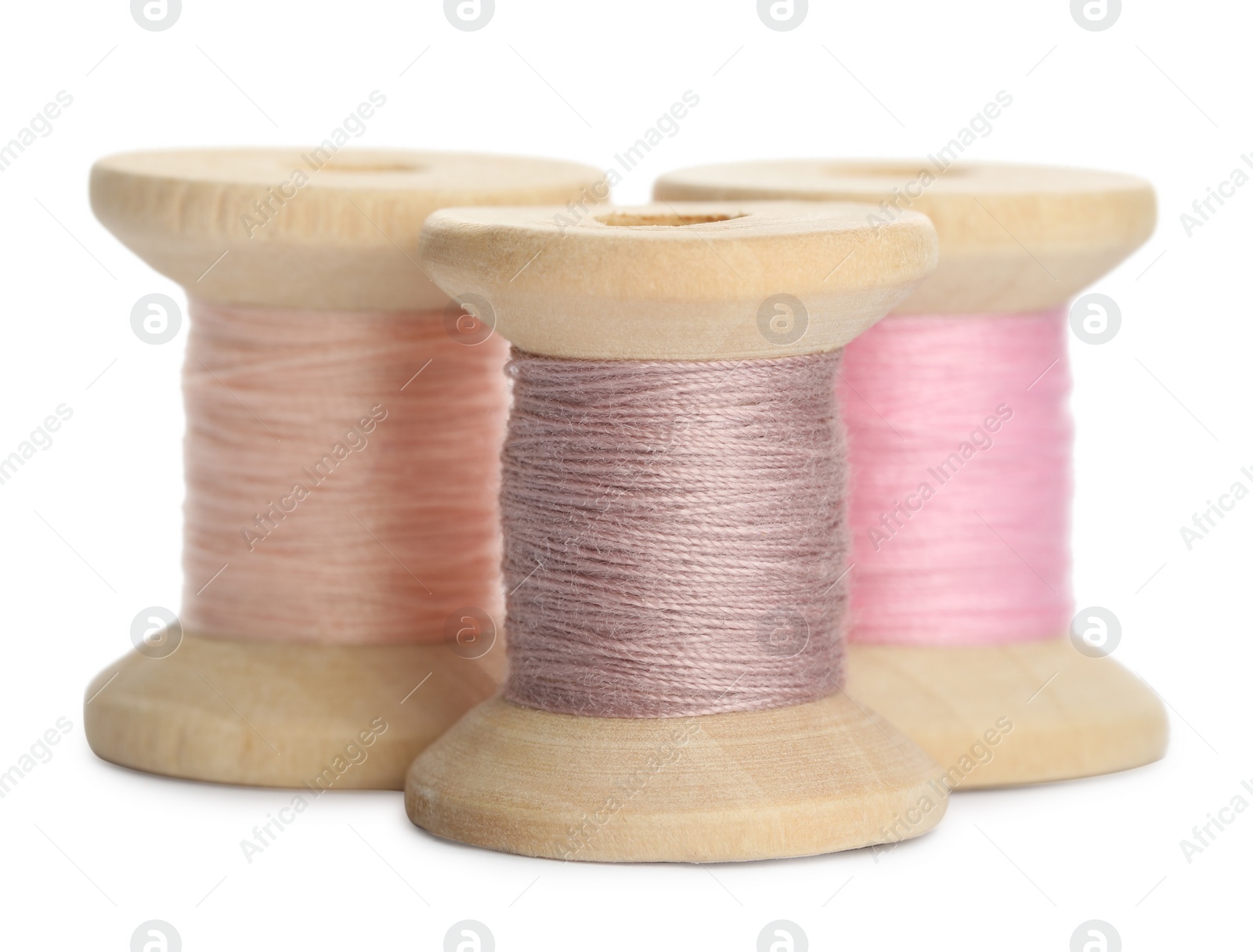 Photo of Different colorful sewing threads on white background, closeup