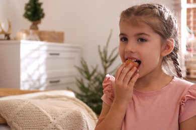 Photo of Cute little child eating fresh tangerine at home, space for text