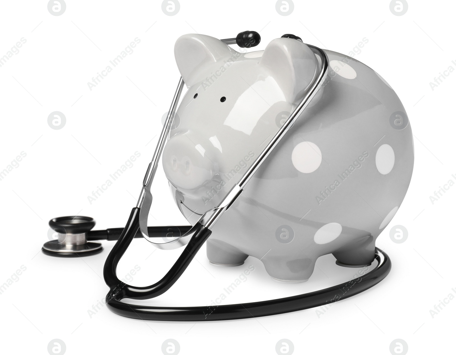 Photo of Piggy bank with stethoscope on white background. Medical insurance