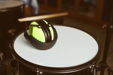 Closeup view of modern drum and headphones in studio