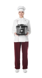 Full length portrait of female chef with modern multi cooker on white background