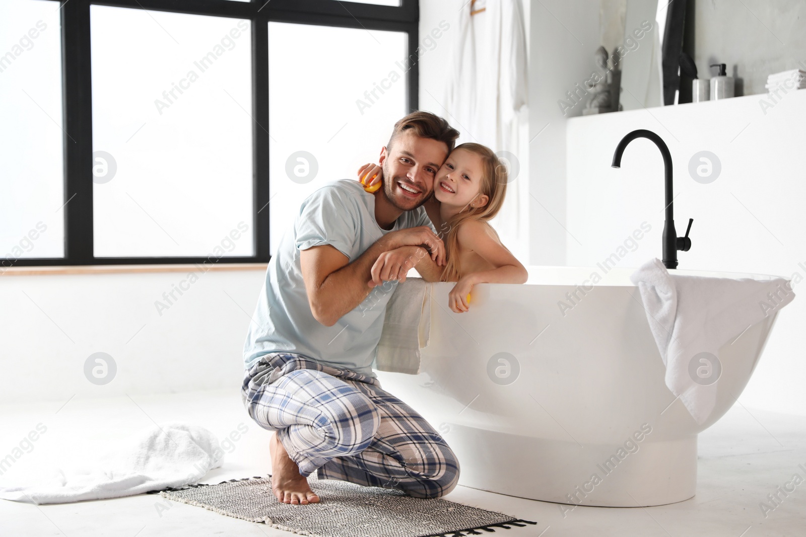 Photo of Father and his cute little daughter in bathroom