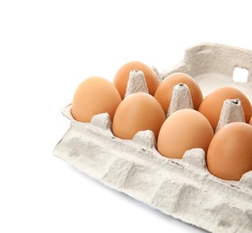 Photo of Carton of raw chicken eggs on white background