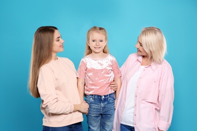Photo of Portrait of young woman, her daughter and mature mother on color background