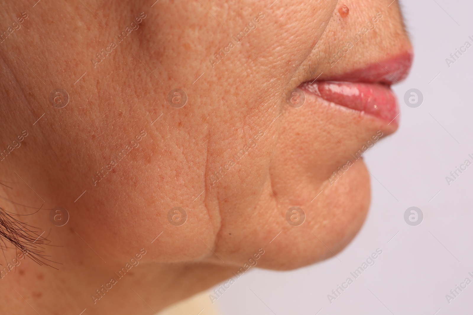 Photo of Closeup view of older woman on white background