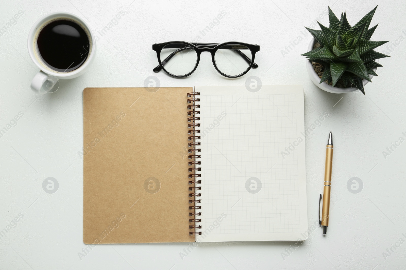 Photo of Flat lay composition with open notebook on white table. Space for text