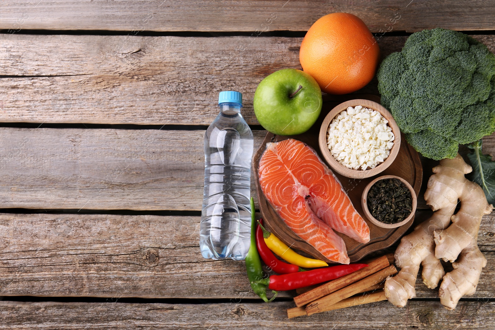 Photo of Metabolism. Different food products on wooden table, flat lay with space for text