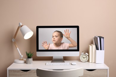 Image of Internet addiction. Little girl trapped in computer. Child stuck to monitor from inside