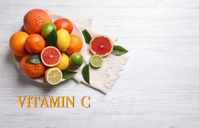 Source of Vitamin C. Different citrus fruits on white wooden table, flat lay