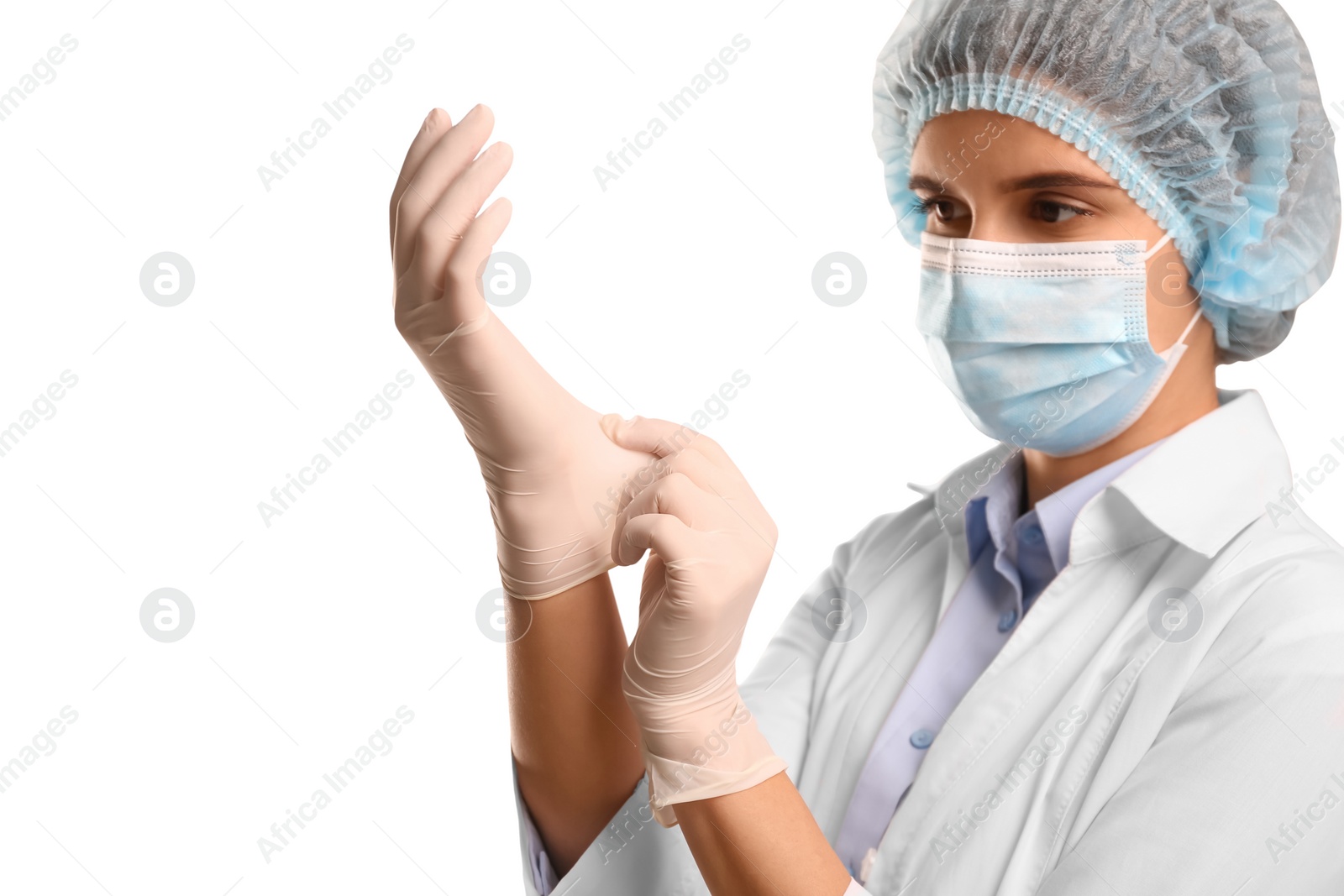 Photo of Doctor in mask putting on medical protective glove against white background