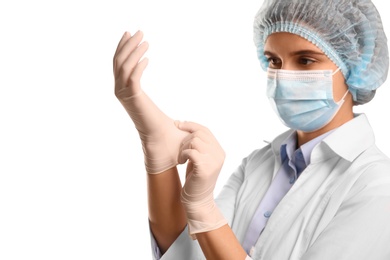 Doctor in mask putting on medical protective glove against white background