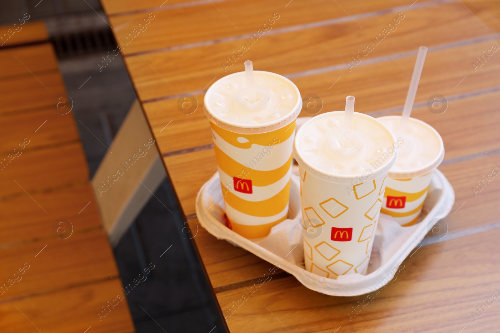 Photo of MYKOLAIV, UKRAINE - AUGUST 11, 2021: Cold McDonald's drinks on table in cafe