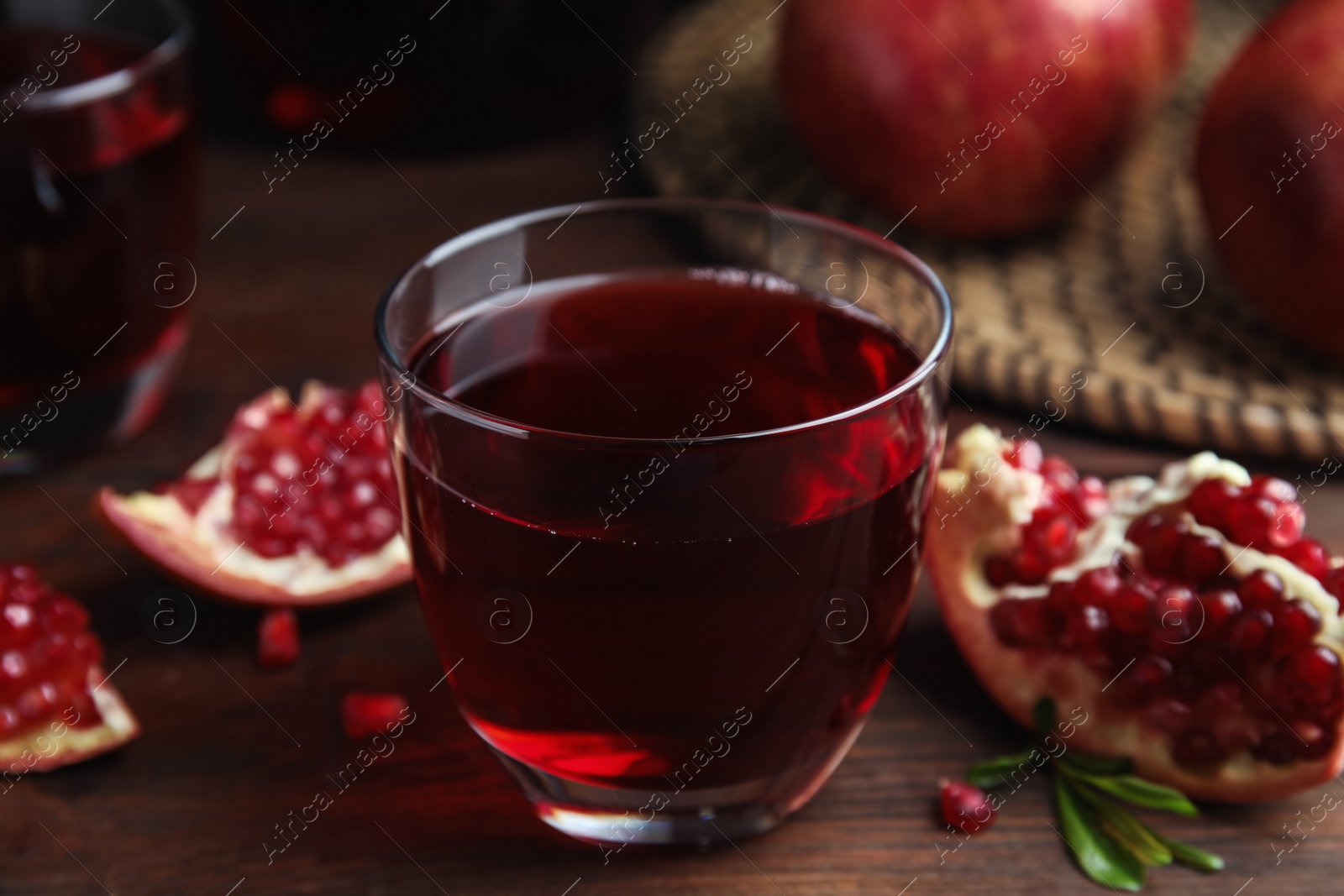 Photo of Pomegranate juice and fresh fruits on wooden table