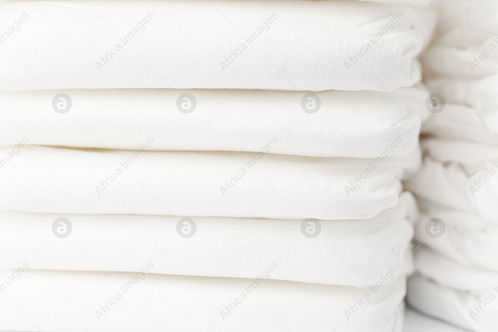 Photo of Stack of baby diapers as background, closeup