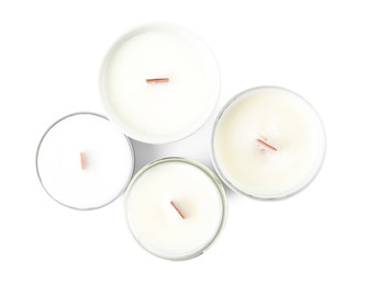 Photo of Beautiful candles with wooden wicks on white background, top view