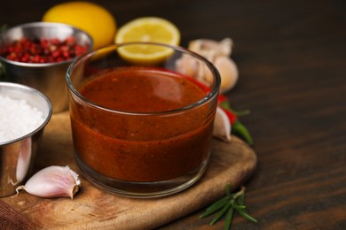 Photo of Fresh marinade and ingredients on wooden table, closeup. Space for text