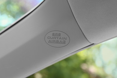 Photo of Safety airbag sign on pillar panel inside car