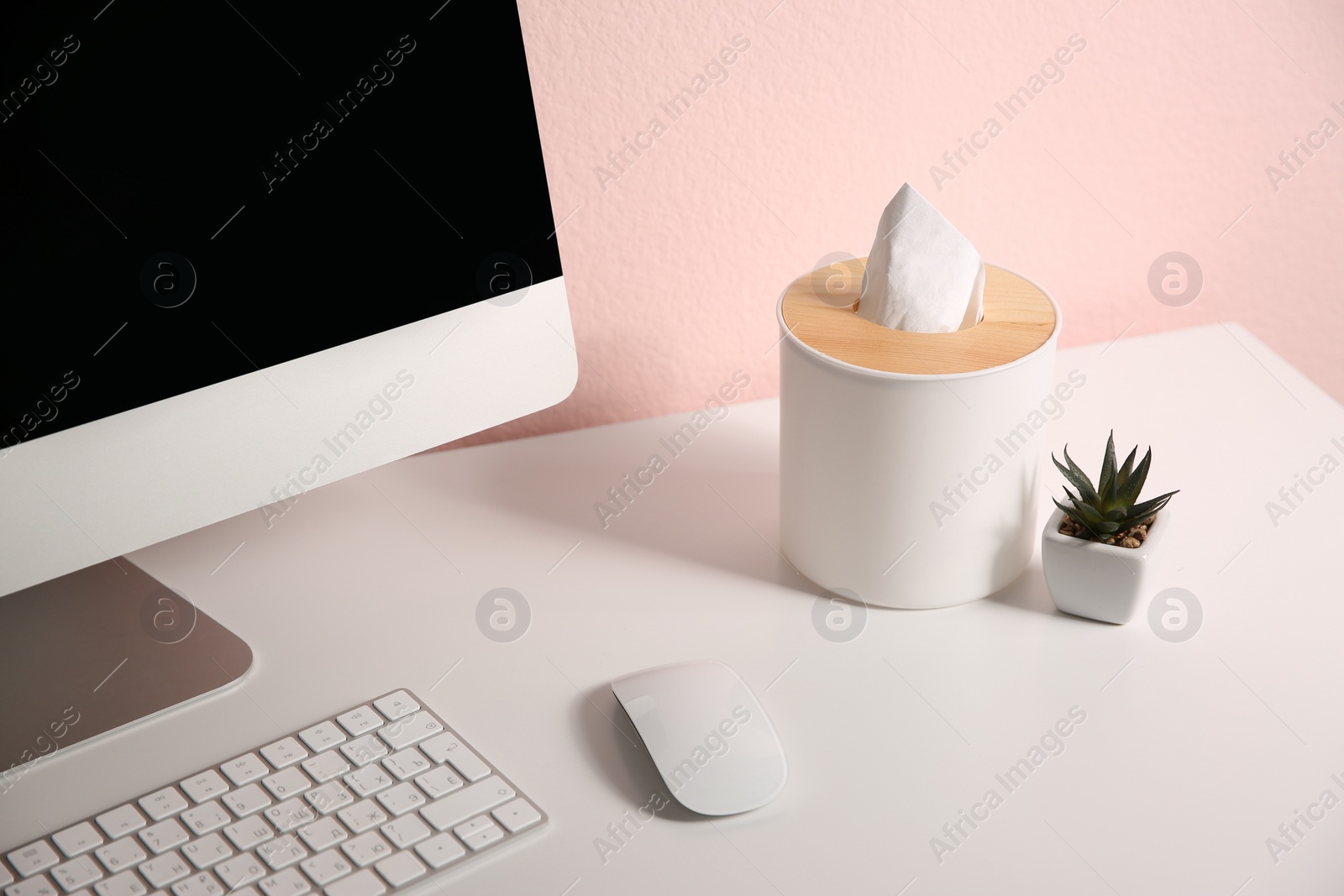 Photo of Box with paper tissues on white table at workplace