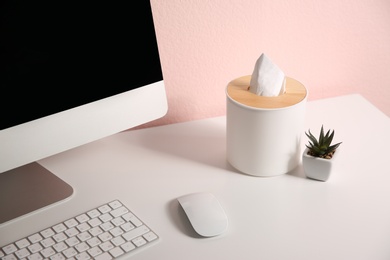 Photo of Box with paper tissues on white table at workplace