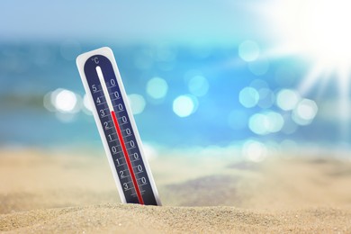 Image of Thermometer on beach showing high temperature during summer day
