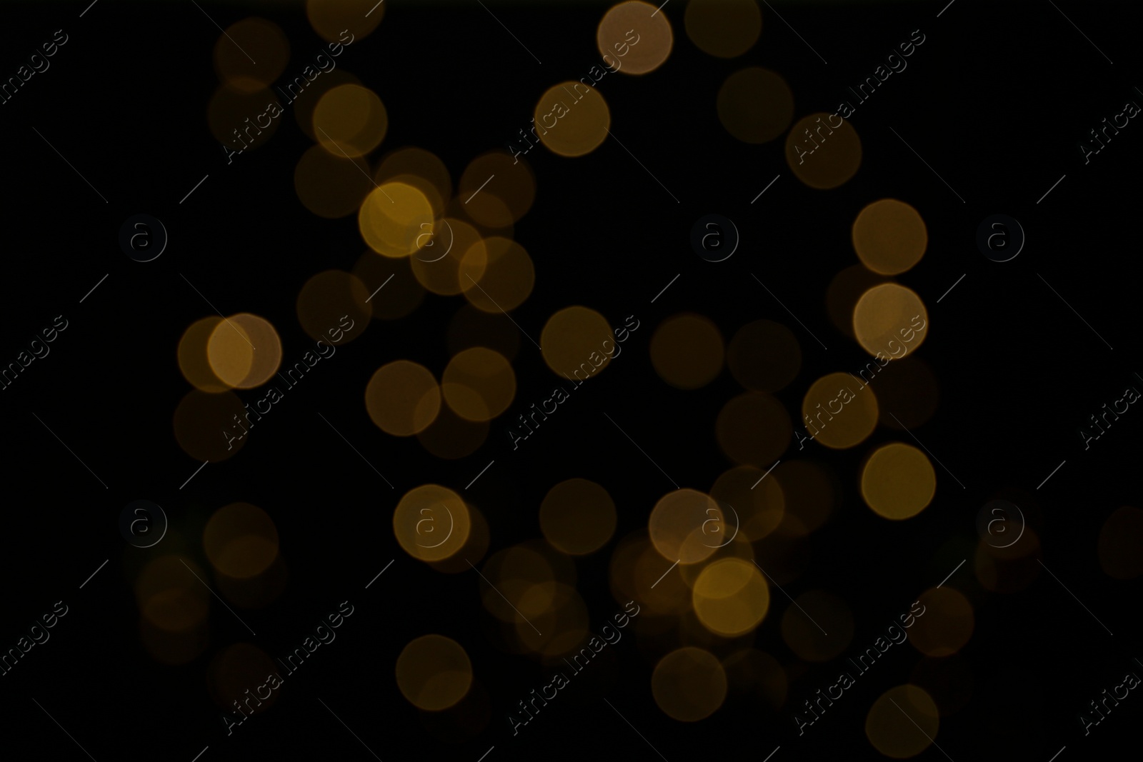 Photo of Blurred view of beautiful lights on black background. Bokeh effect