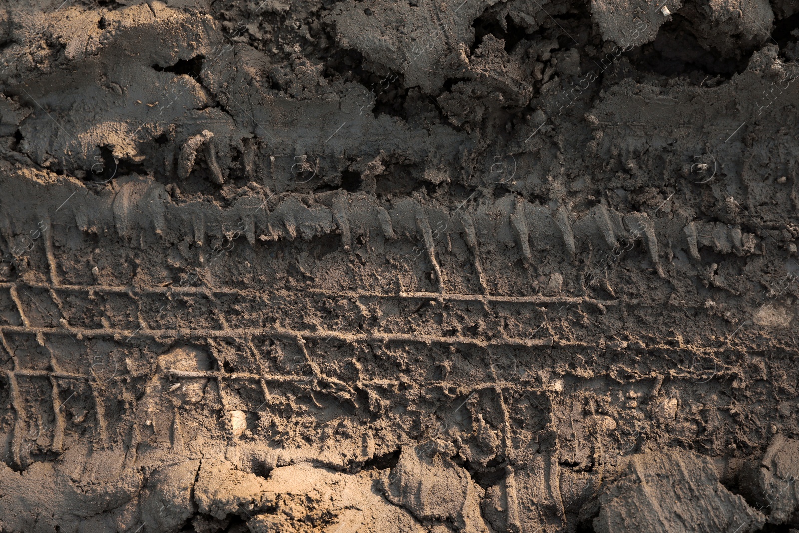 Photo of Ground mud with tire track as background, closeup