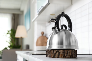 Photo of Modern kettle on kitchen counter indoors, space for text