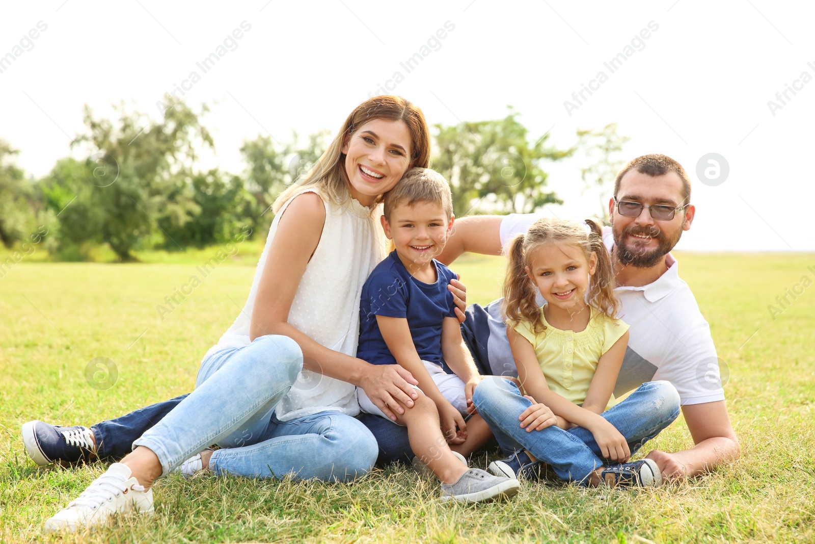 Photo of Happy family spending time together with their children outdoors