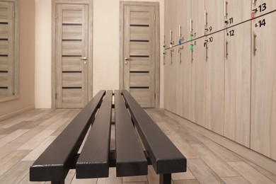 Wooden bench near lockers in changing room