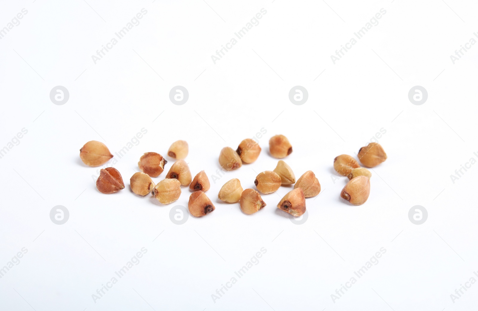 Photo of Uncooked buckwheat on white background. Healthy diet