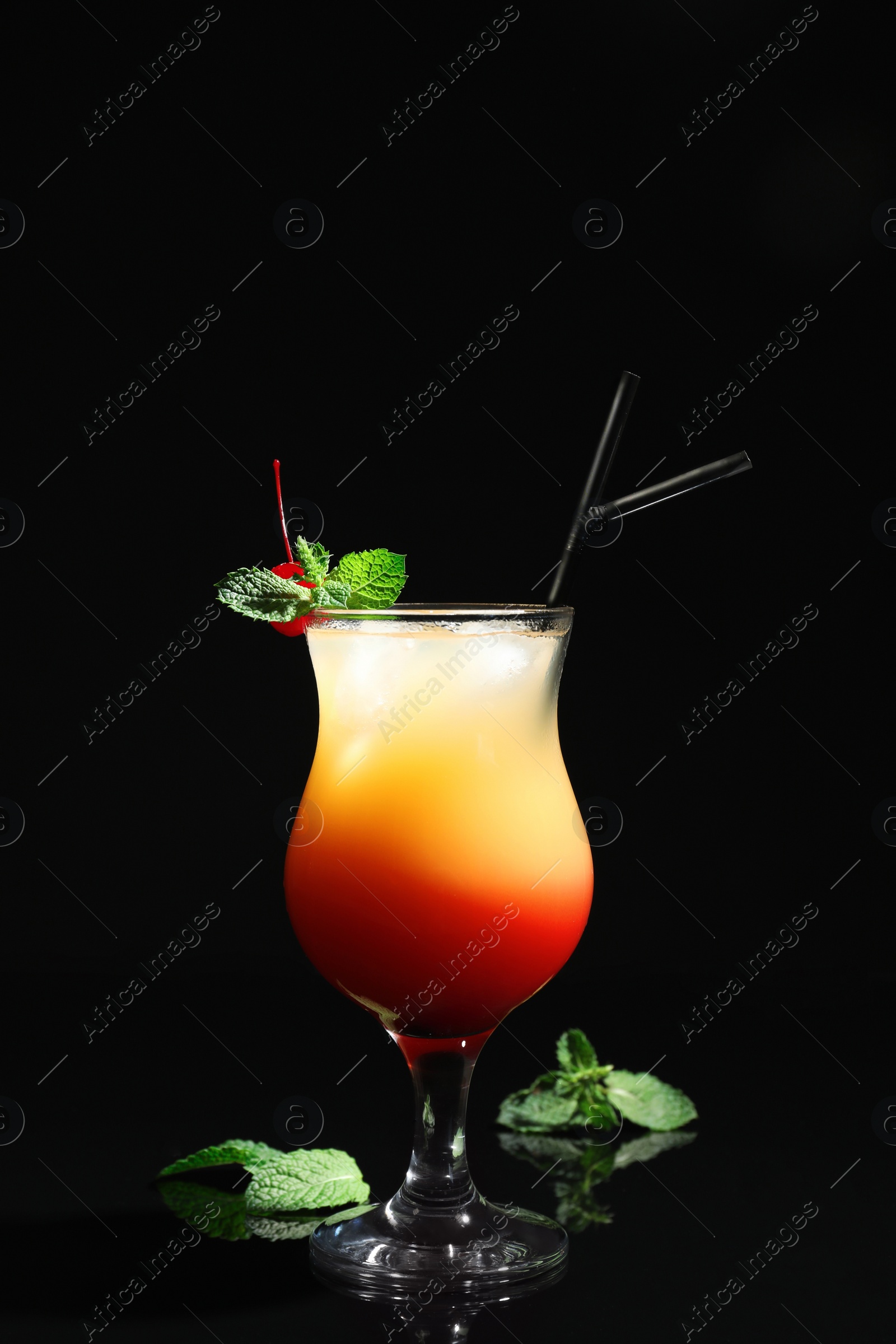 Photo of Just made appetizing cocktail Sex on the Beach, black background