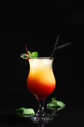 Photo of Just made appetizing cocktail Sex on the Beach, black background