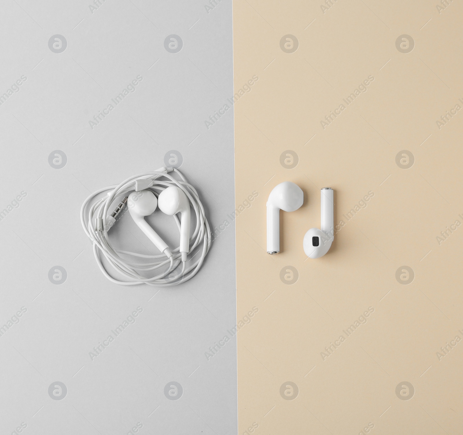 Photo of Flat lay composition with different earphones on color background