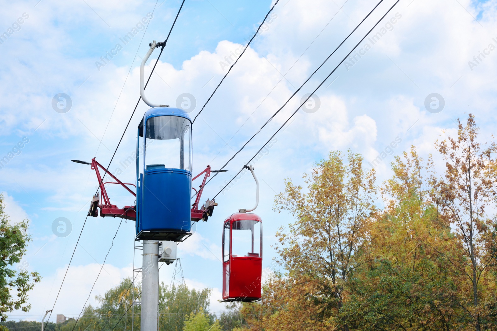 Photo of View of cableway with bright cabins on autumn day