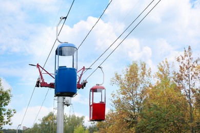 Photo of View of cableway with bright cabins on autumn day