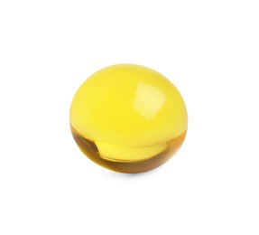 One yellow pill on white background. Medicinal treatment