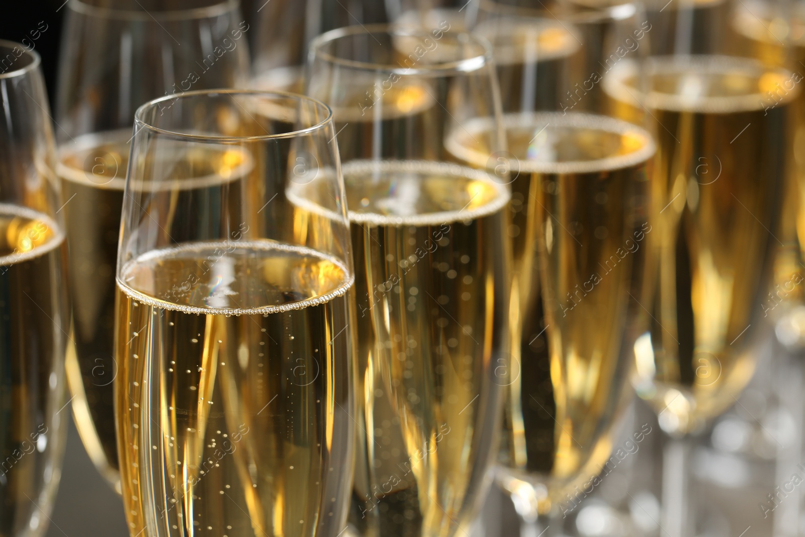 Photo of Many glasses of champagne, closeup. Festive drink