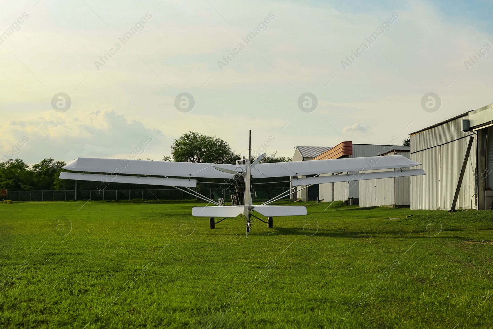 Photo of Modern white airplane on green grass outdoors