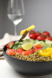 Bowl of salad with mung beans on white table, closeup