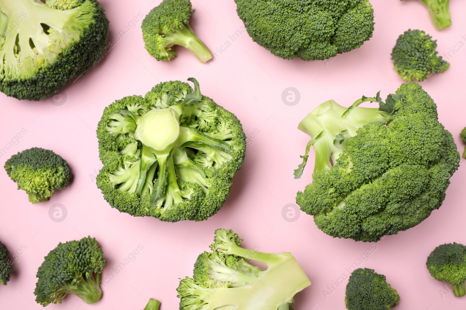 Photo of Fresh broccoli on pink background, flat lay