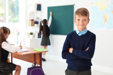 Little boy in classroom. Stylish school uniform