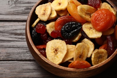 Mix of delicious dried fruits on wooden table, above view